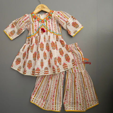 Traditional outfit with floral patterns on a gray background